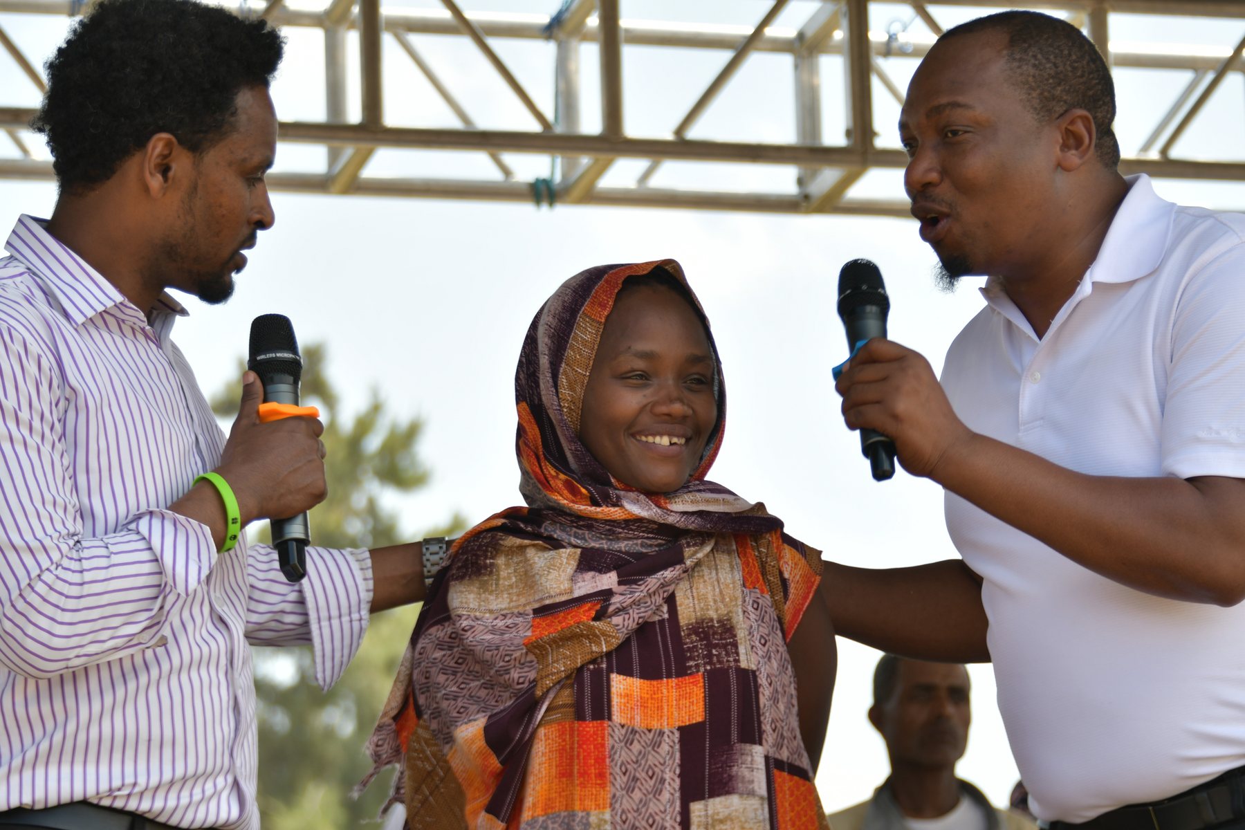 A young woman praying in a crowd