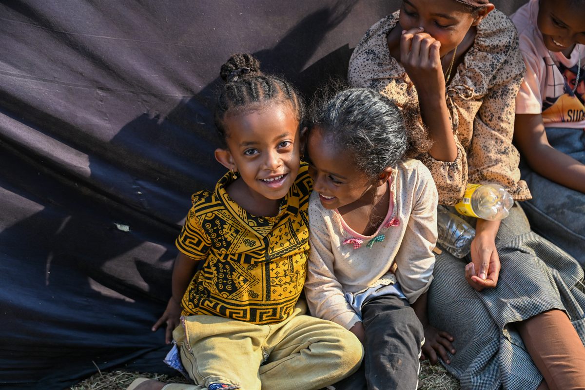 Children smiling in the crowd