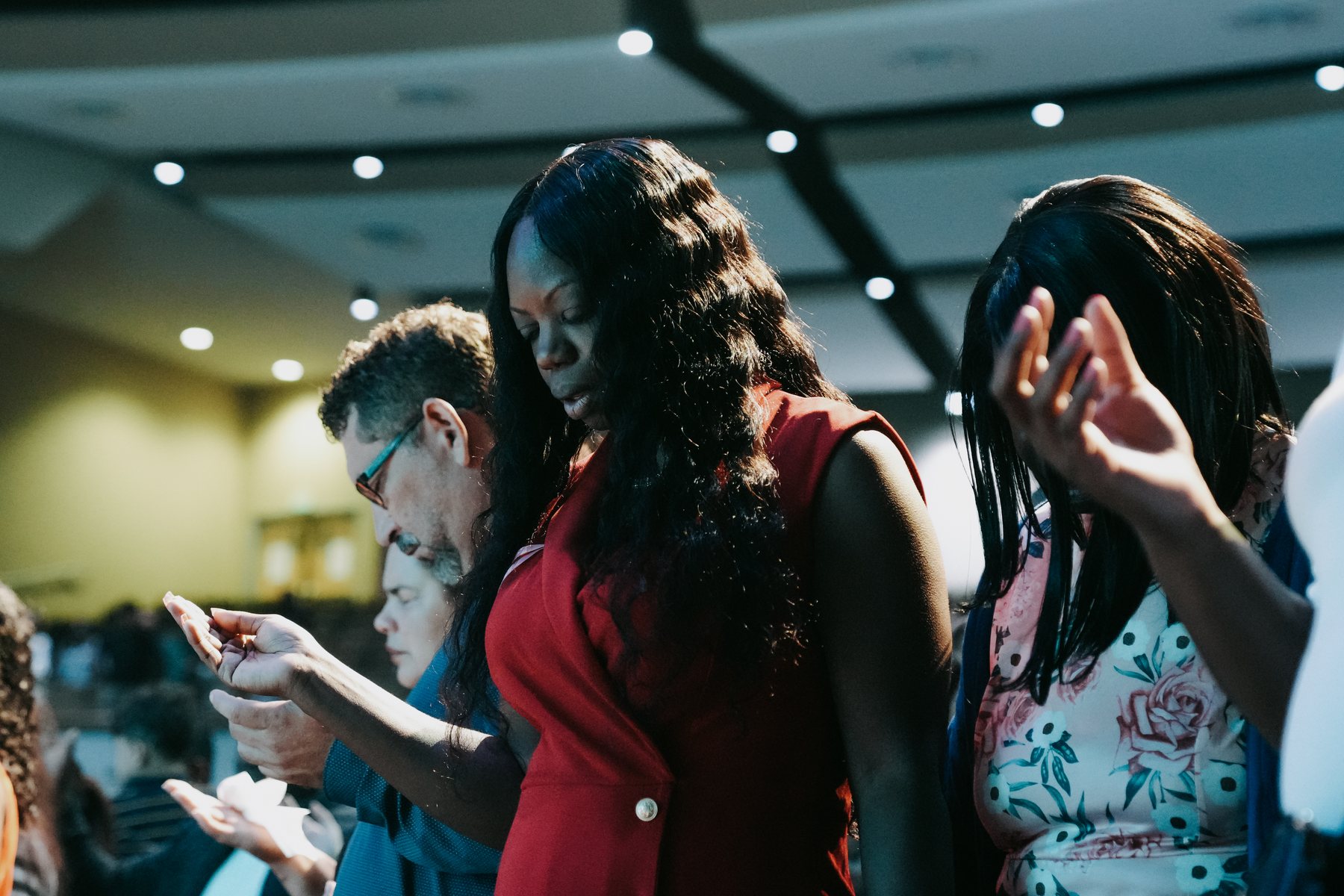 People praying with hands raised