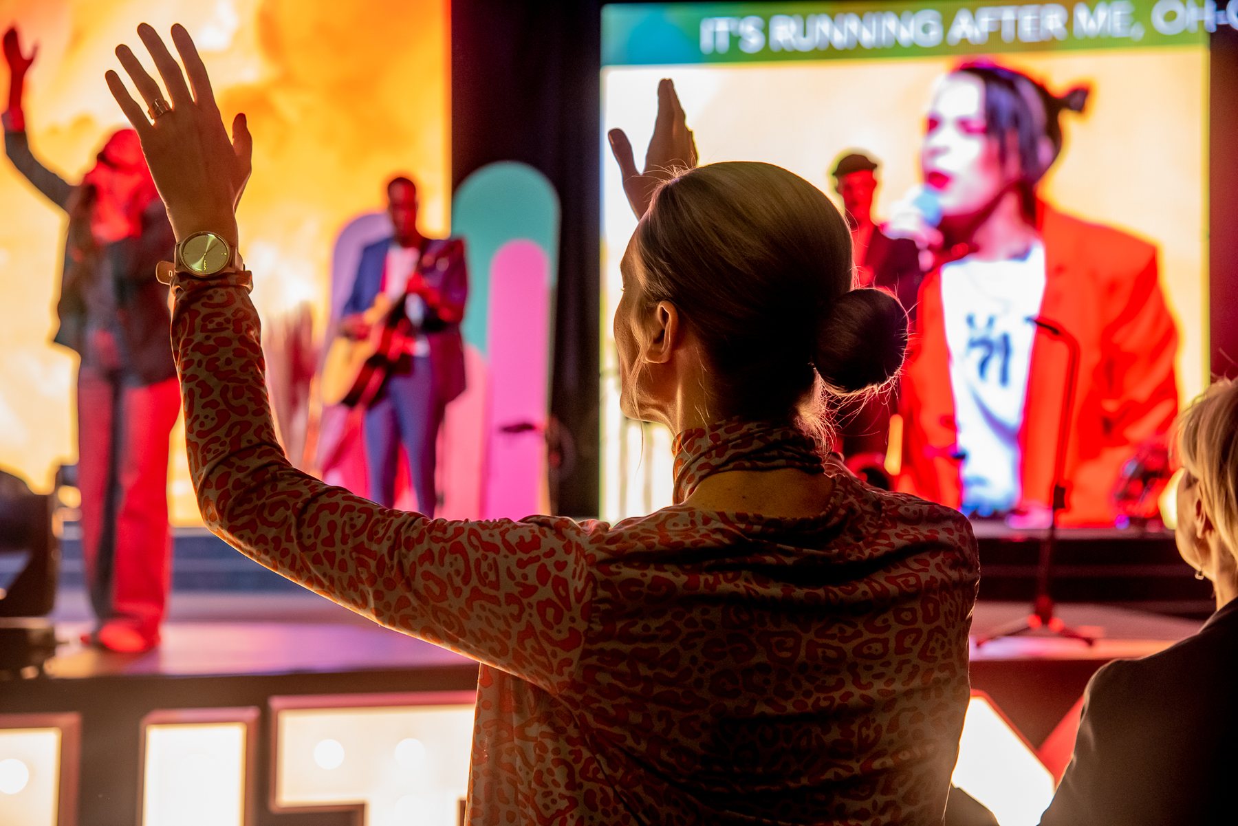 Hands lifted in worship at an invitation event