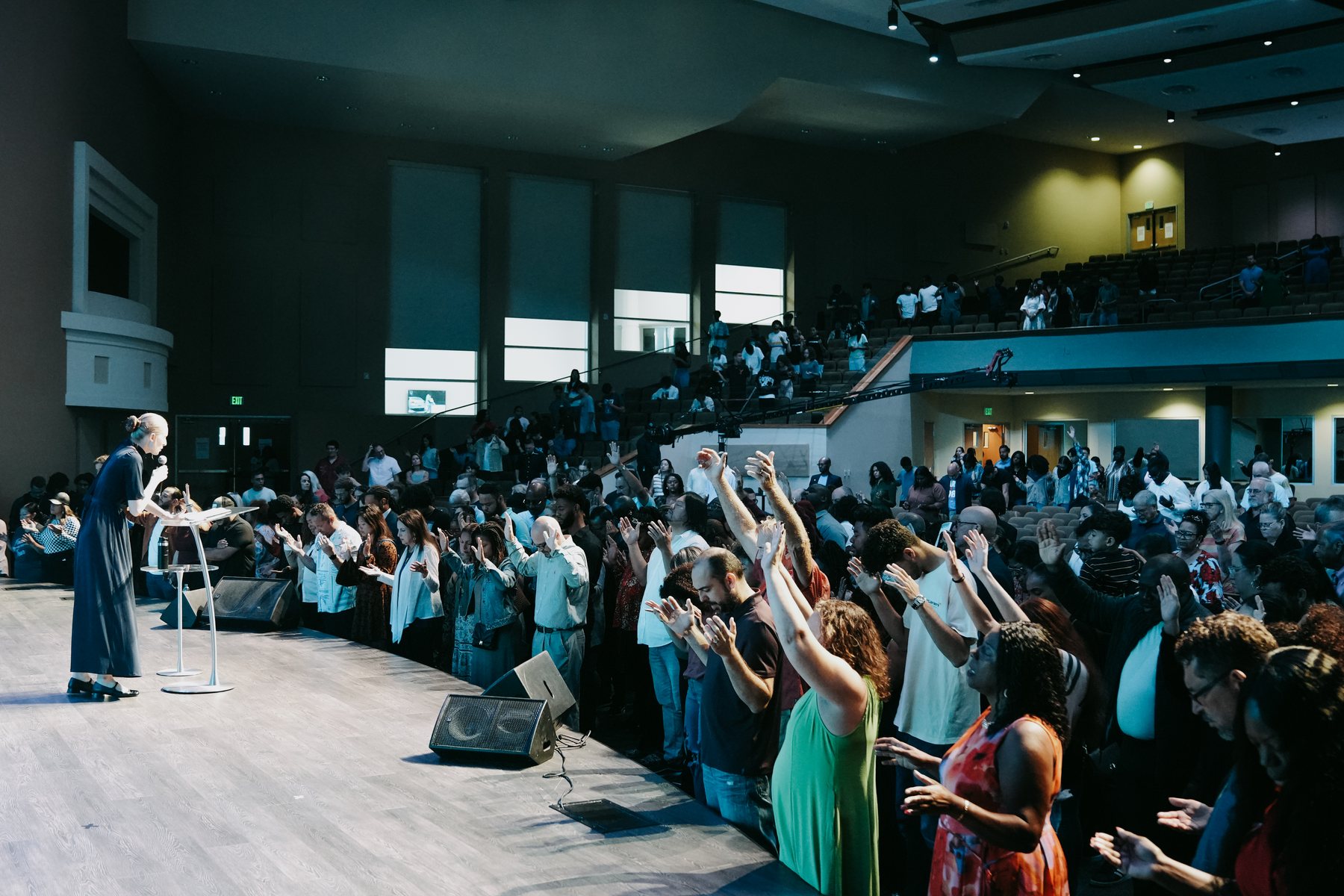 People gathered at an In His Name invitation event