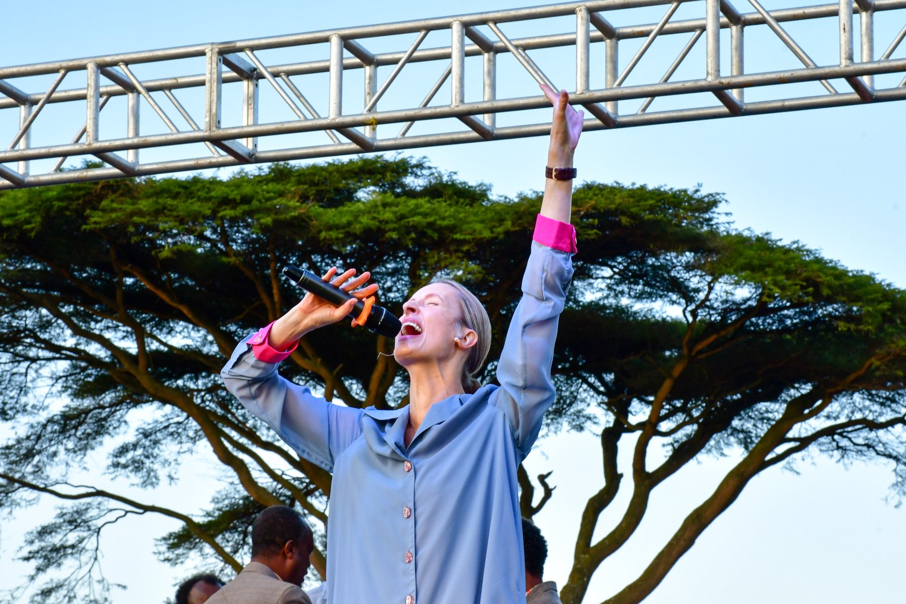 Tamryn speaking from an outdoor stage